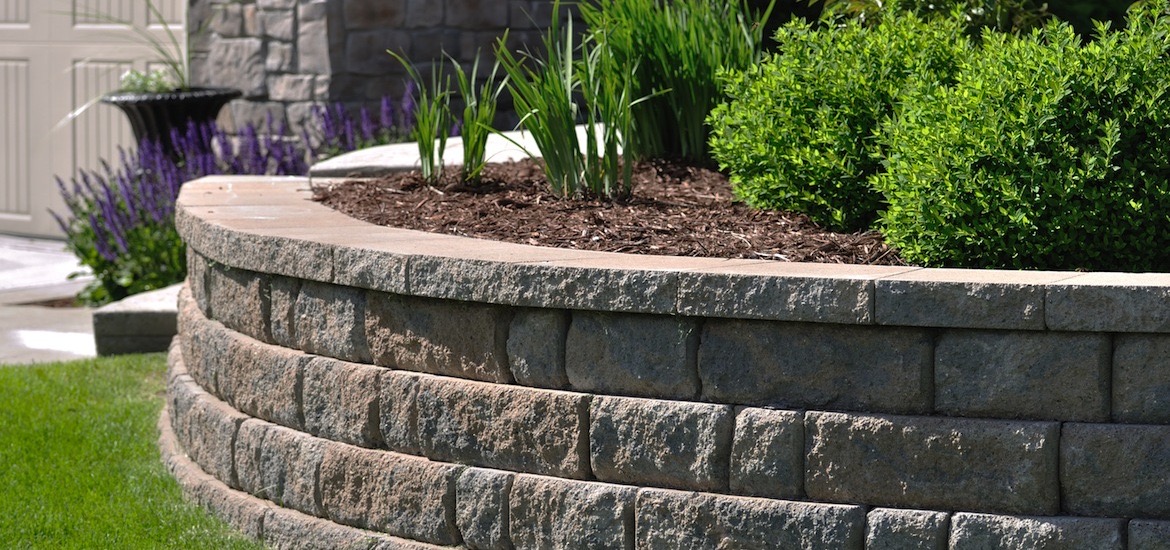 Brick paver retaining wall and planting bed